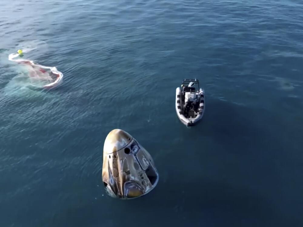 In this image taken from video provided by NASA, a SpaceX capsule floats in the Gulf of Mexico, Tuesday, March 18, 2025, after landing off the coast of Florida with NASA astronauts Suni Williams, Butch Wilmore and Nick Hague, and Russian cosmonaut Alexander Gorbunov.