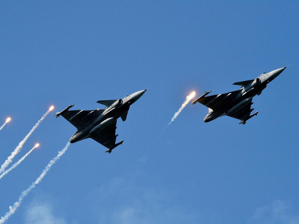 Gripen fighter jets of the Hungarian Air Force fire their infrared countermeasure over the Danube River in Budapest on Aug. 20, 2019, during an air show.