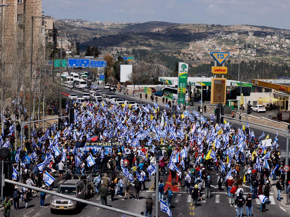 Israelis holding national flags march into Jerusalem during a demonstration on Wednesday calling for the end of the war and the release of the remaining hostages held captive in Gaza since the October 7, 2023 attacks by Palestinian militants.