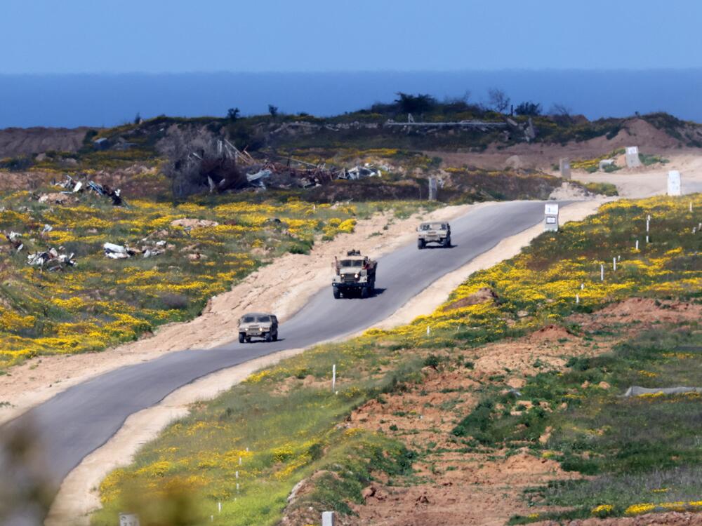 In this picture, taken from Israel's southern border with the Gaza Strip, Israeli soldiers patrol a street in northern Gaza on Wednesday. The Israeli military says it's launched a new ground offensive in Gaza, a day after Israel broke a ceasefire with a punishing series of airstrikes that killed more than 400 people.