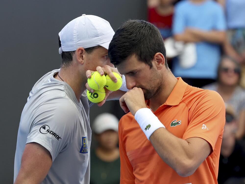 Canada's Vasek Pospisil and Serbia's Novak Djokovic talk tactics during their double match against during their Round of 32 match at the Adelaide International Tennis tournament in Adelaide, Australia, Jan. 2, 2023.