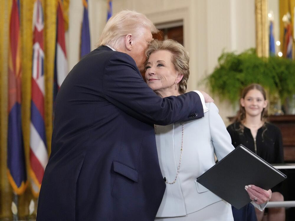President Donald Trump, left, hugs U.S. Secretary of Education Linda McMahon after he signed an executive order in the East Room of the White House on Thursday.