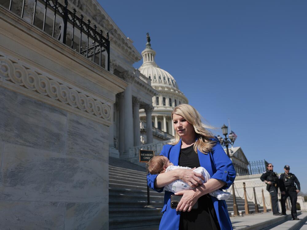 U.S. Rep. Brittany Pettersen, D-Colo., holds her baby as she departs during a series of votes at the Capitol on March 11 in Washington, D.C.