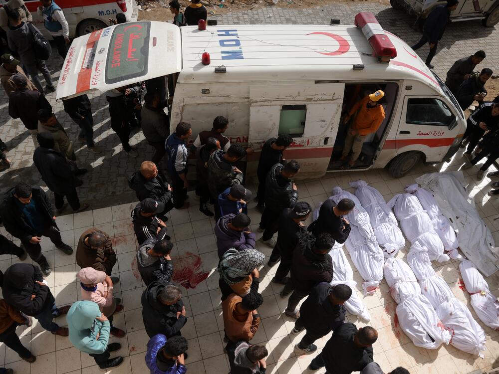 Palestinians recite a prayer over the bodies of victims of Israeli overnight airstrikes in the northern Gaza Strip, in front of the Indonesian Hospital in Beit Lahia on Thursday.