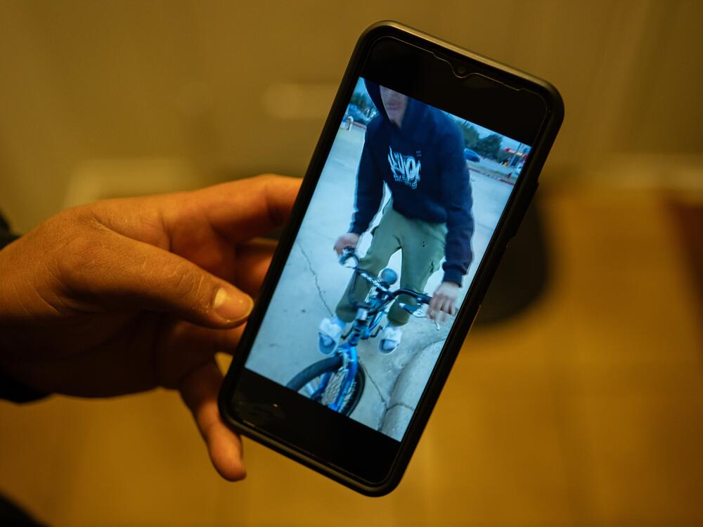 Juan plays a video of his son Carlos riding a bike, which Carlos purchased the day before being taken into custody, at his home in Cedar Park, Texas, on Jan. 29, 2025.
