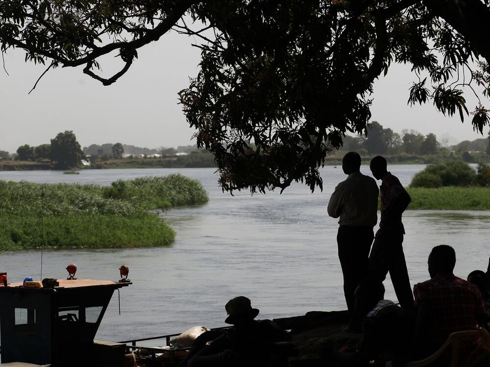Southern Sudanese who have returned to the south by barges  stand on the banks of the Nile river in Juba's port on Jan. 10, 2011.