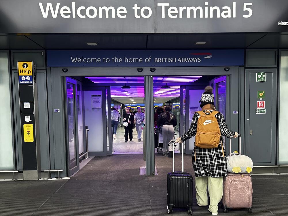 Travellers arrive at Terminal 5 as Heathrow Airport slowly resumes flights after a fire cut power to Europe's busiest airport in London, on Saturday.