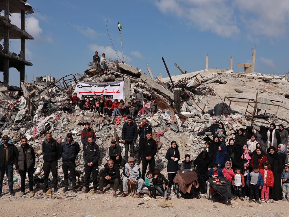 Surviving members of the Abu Naser family gather for a portrait in front of their destroyed family home during a recent ceasefire in northern Gaza.