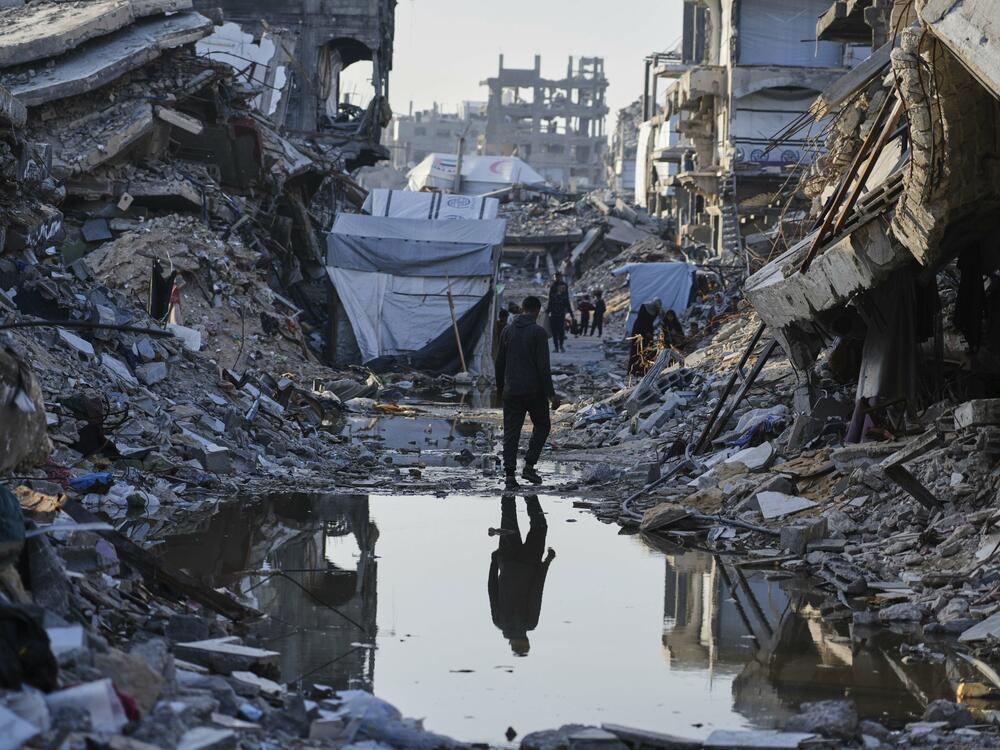 Palestinians walk amid the rubble of destroyed homes and buildings in Jabaliya, northern Gaza Strip, March 14.