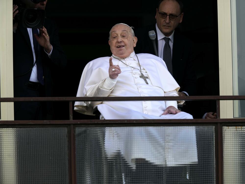 Pope Francis gestures as he appears at a window of the Agostino Gemelli Polyclinic in Rome on Sunday.