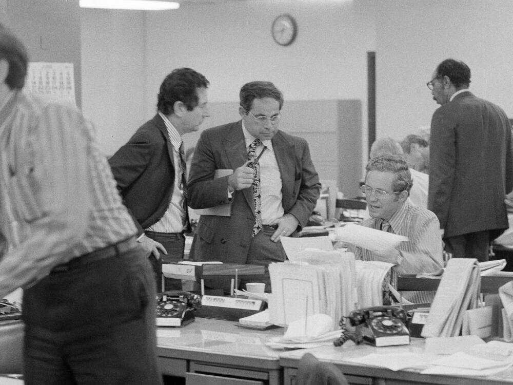 The city room of <em>The New York Times</em> is pictured on June 15, 1971. From left are <em>Times</em> editors James L. Greenfield, foreign editor; Max Frankel, chief Washington correspondent; and Fred P. Graham from the <em>Times</em> Washington bureau. Frankel went on to be the paper's top editor.