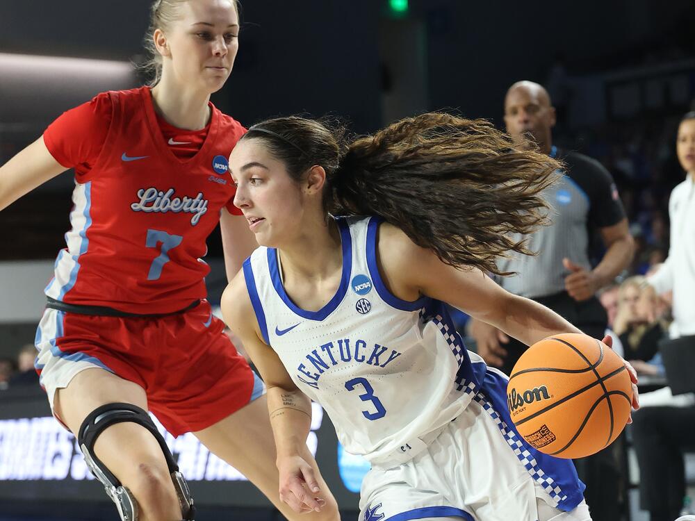 Georgia Amoore #3 of the Kentucky Wildcats drives around Pien Steenbergen #7 of the Liberty Lady Flames during the second half in the first round of the NCAA Women's Basketball Tournament on March 21, 2025 in Lexington, Kentucky.