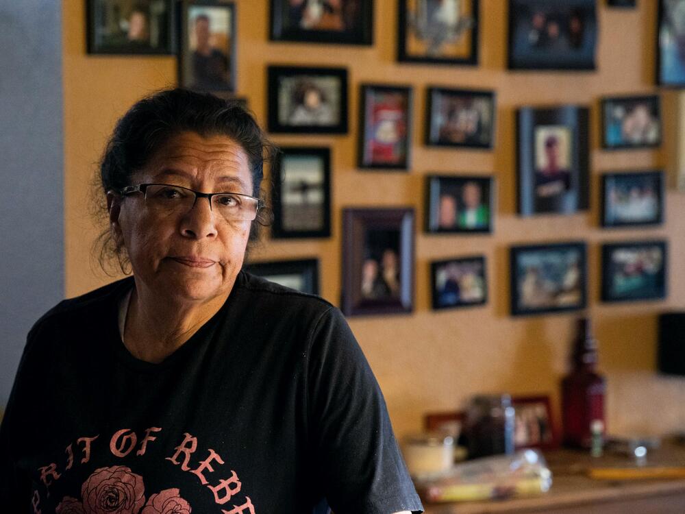 Irma Nunez stands inside her client Thomas Draa's home. She used to pick up as much work as she could to make ends meet.