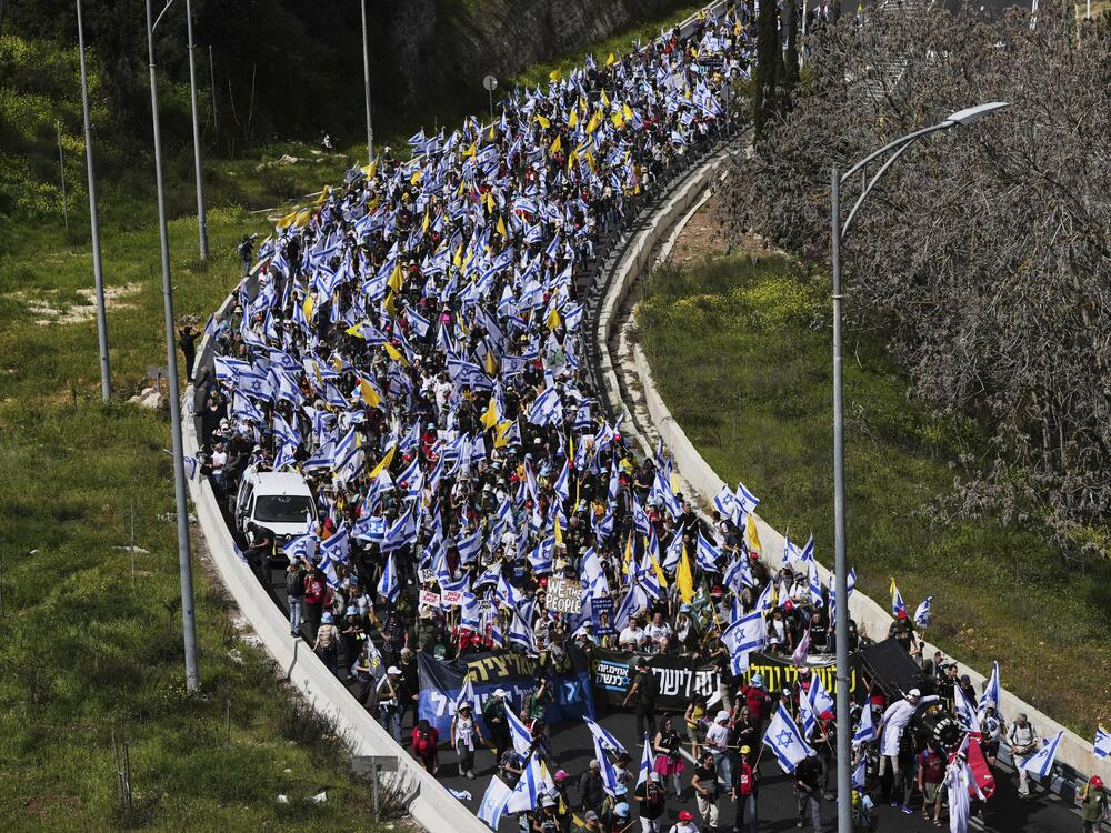 Israelis march on a highway toward Jerusalem to protest Prime Minister Benjamin Netanyahu's plans to dismiss the head of the Shin Bet internal security service, on March 19.
