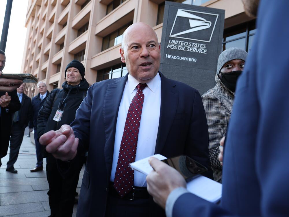 Louis DeJoy, the outgoing U.S. postmaster general, speaks to reporters in 2022 in Washington, D.C. On Monday, he announced that he is stepping down.