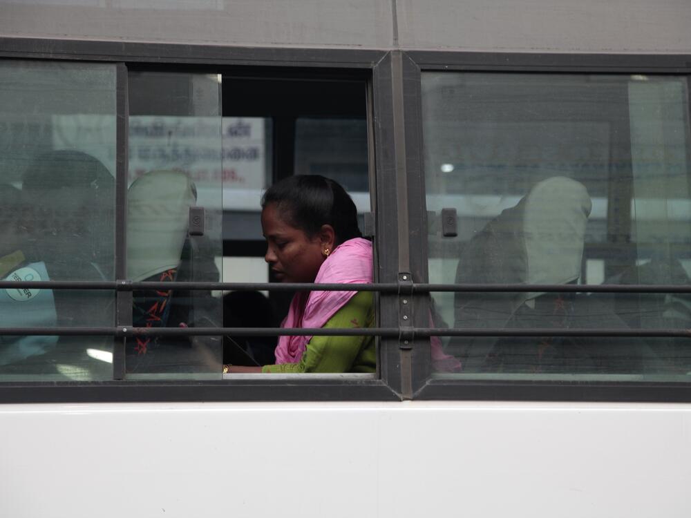 A woman sits on a bus in Sriperumbudur district in the southern Indian state of Tamil Nadu, where many women are employed in manufacturing. India hopes to attract more business as the Trump administration imposes tariffs on China.