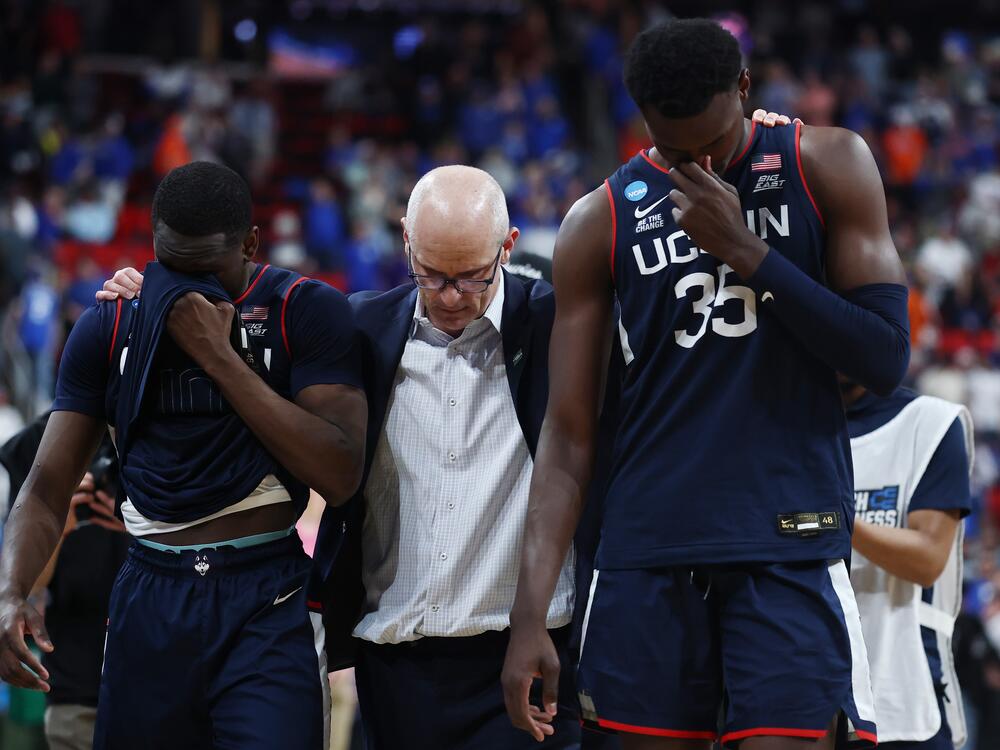 Head coach Dan Hurley of the Connecticut Huskies walks off the court with Hassan Diarra,left, and Samson Johnson after losing to the Florida Gators 77-75 in the second round of the NCAA Men's Basketball Tournament at Lenovo Center on March 23, 2025 in Raleigh, North Carolina.