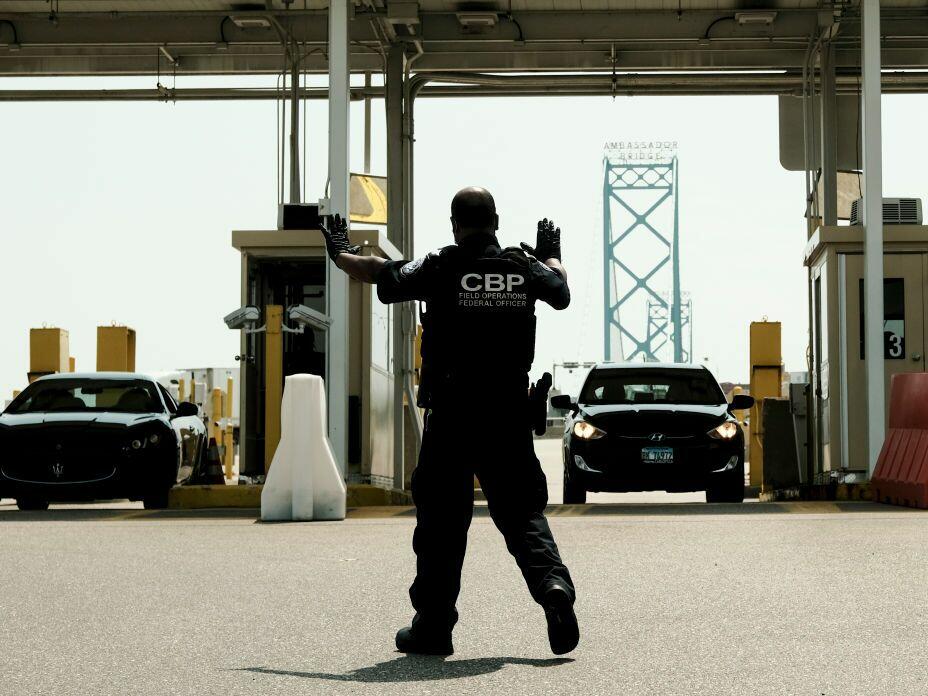 U.S. Customs and Border Protection agents direct vehicles re-entering the U.S. from Canada at the Ambassador Bridge Port of Entry in Detroit.