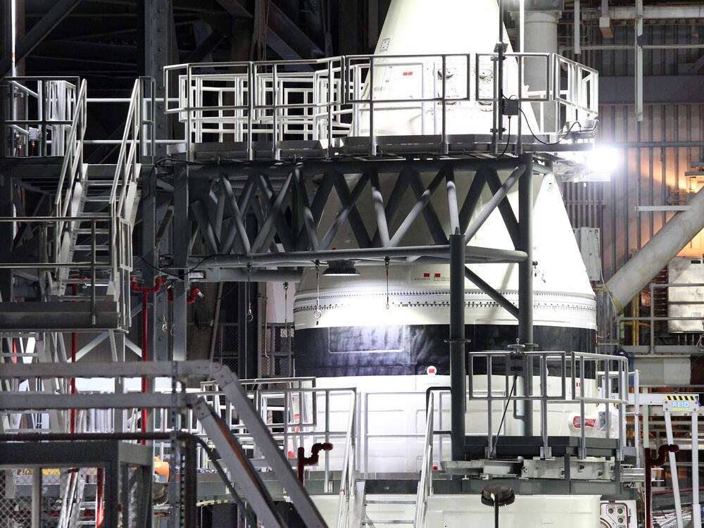 NASA engineers work alongside the tip of a solid rocket booster for the Artemis II Space Launch System (SLS) in NASA's Vehicle Assembly Building at the Kennedy Space Center in Florida in February.