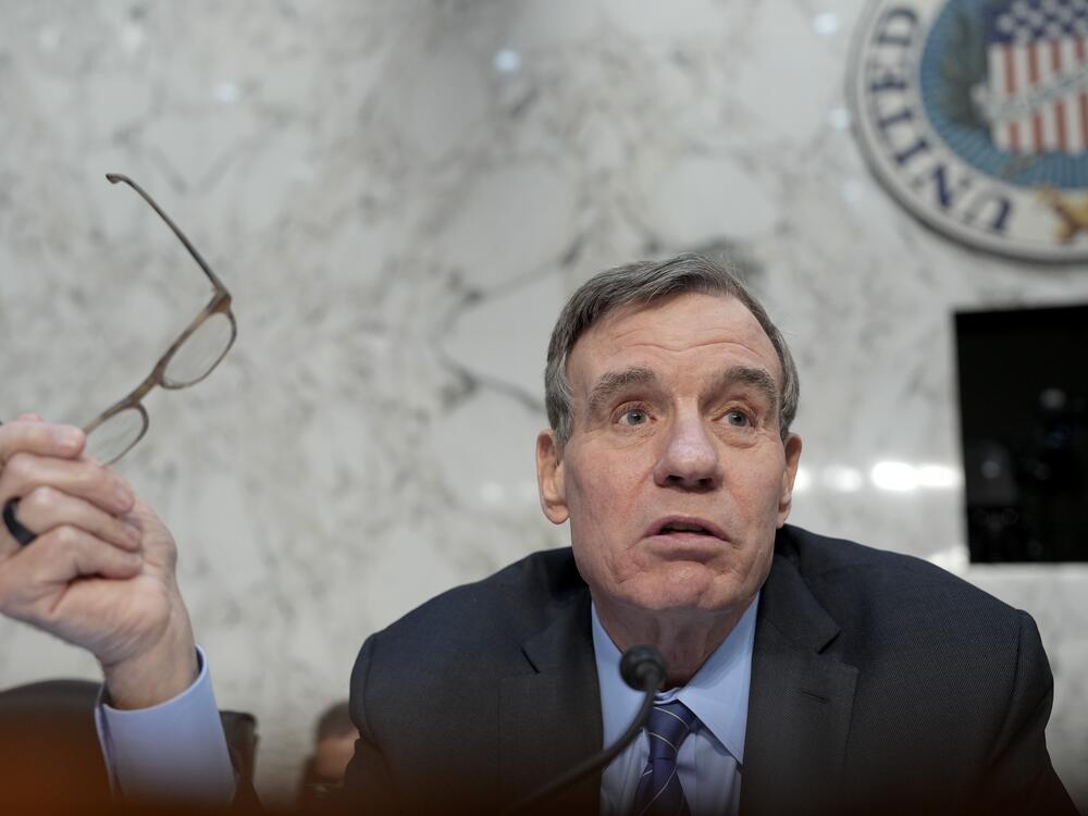 Sen. Mark Warner (D-VA) addresses the nation's top intelligence officials as they appear during a Senate Intelligence Committee hearing on Tuesday.