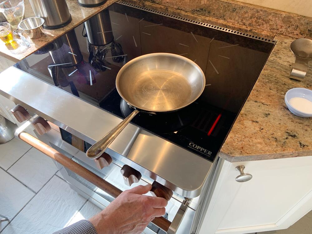 The Copper induction stove has a battery under the oven, so the appliance can plug into a regular household outlet.