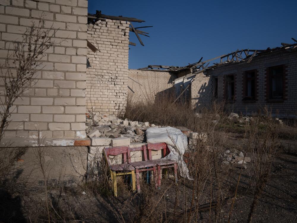 Children's chairs sit outside the remains of a school that was badly damaged in Posad-Pokrovske.