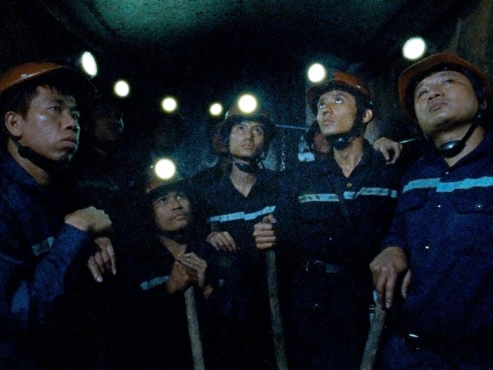 The two main characters of the film, Việt and Nam, are poor coal miners. The film explores their relationship and Nam's desire to leave the country.