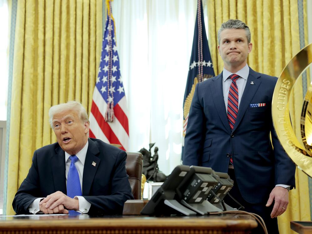 President Trump speaks alongside Secretary of Defense Pete Hegseth in the Oval Office on March 21. Days earlier, Hegseth shared details about overseas war plans in a group chat on Signal, an encrypted, open-source messaging app, according to <em>The Atlantic</em>.