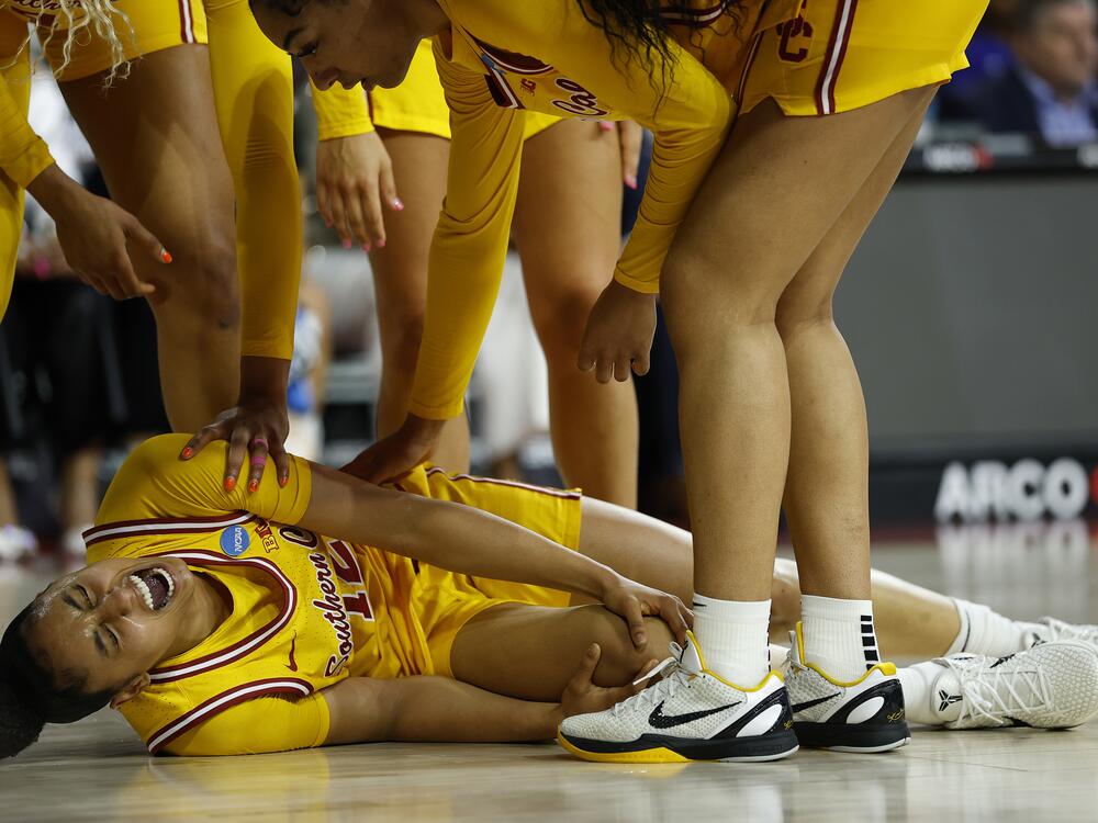 JuJu Watkins of the USC Trojans lies on the court after an injury against the Mississippi State Bulldogs in the first half during the second round of the NCAA Women's Basketball Tournament at Galen Center on March 24, 2025, in Los Angeles.
