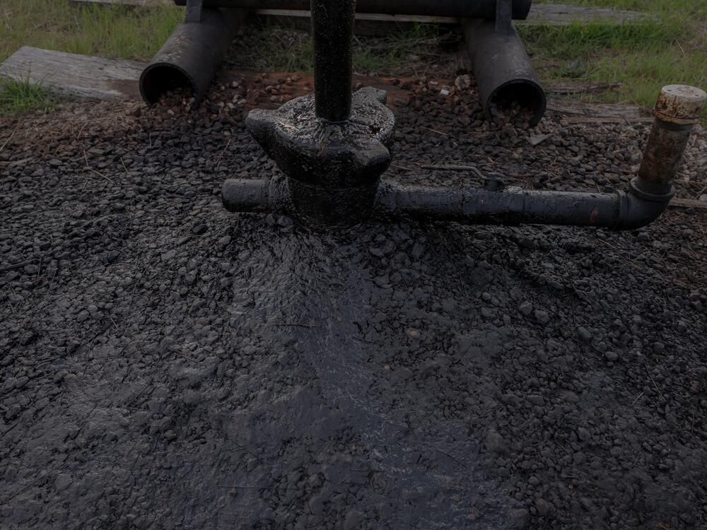 The base of one of Scott Robinowitz's marginal wells shows built-up oil. The wells produce just a few barrels a day, but that small volume can still be profitable. Keeping operating costs low is key to making money on marginal wells, creating tension between environmental groups who want more active monitoring for pollution risks and companies that want to keep costs down.