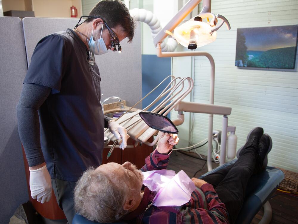 James Flanagin, the only dentist in Leslie, Ark., treats David Potts.  About 25 million Americans live in dentist shortage areas, according to new research from Harvard University.