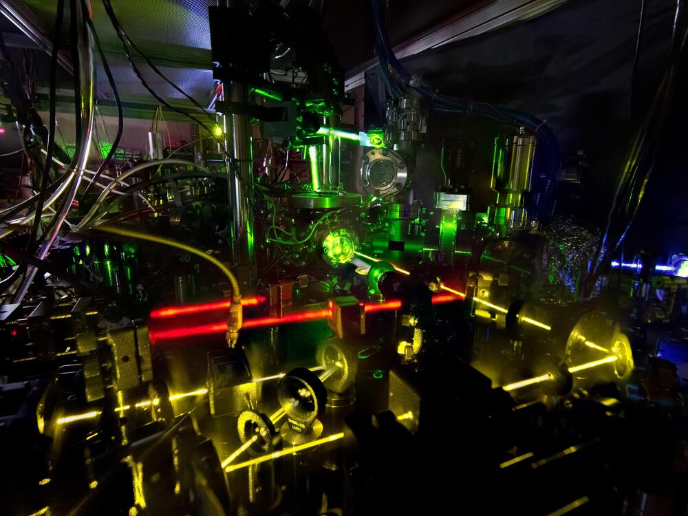 Lasers shine as part of an advanced atomic clock at NIST. Precise measurements of the colors of light emitted by atoms are essential to everything from atomic clocks to medical devices.