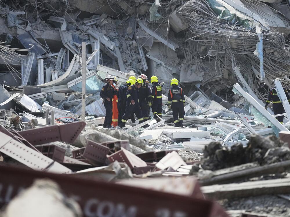 Rescuers work at the site of a high-rise building under construction that collapsed after a 7.7 magnitude earthquake in Bangkok, Thailand on Friday.