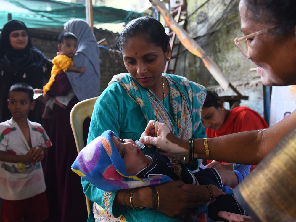 A health care worker administers a measles vaccine to a child at a temporary vaccination camp following an outbreak in Mumbai. India is among the countries that get vaccination support from Gavi, the Vaccine Alliance, whose USAID funding has been terminated.