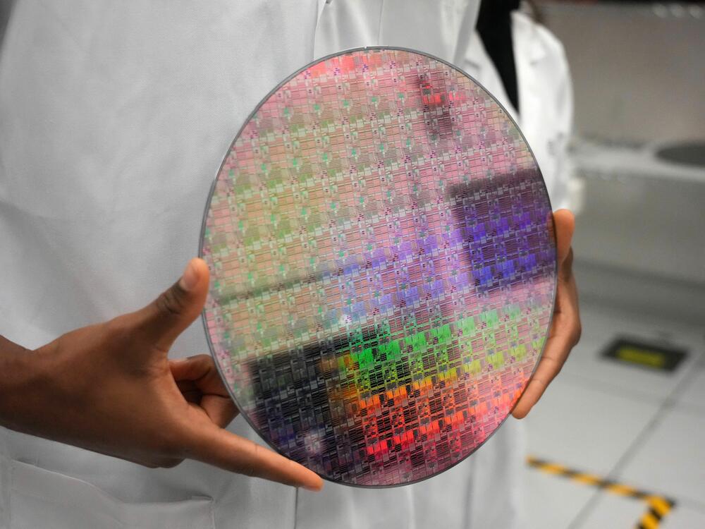 A silicon wafer with microchips etched into it. Microchips are etched using specific wavelengths of light. Better measurements of ultraviolet light are required to advance chip manufacturing.