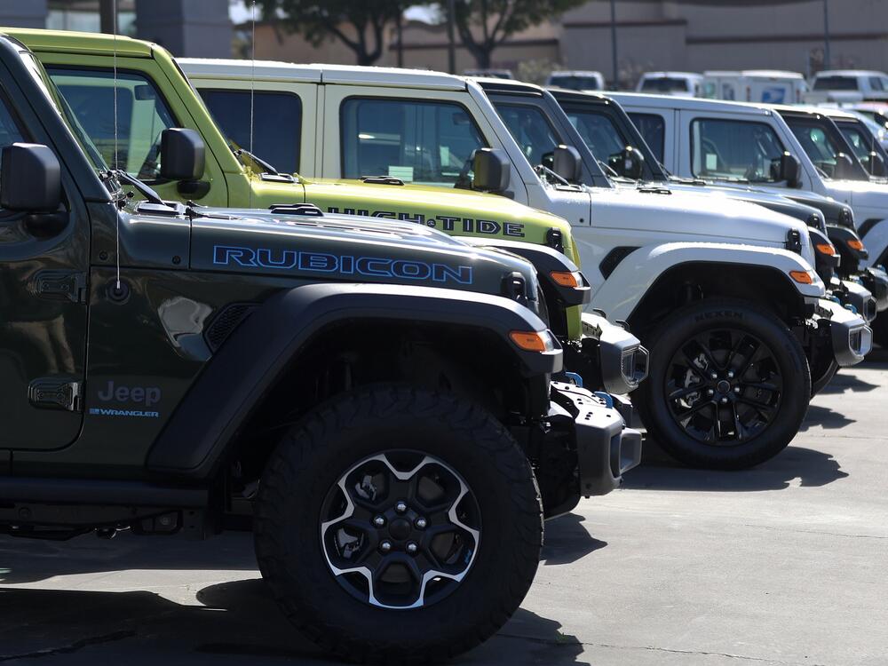 Jeep Wrangler 4Xe plug-in hybrids displayed on the sales lot at Hilltop Chrysler Jeep Dodge Ram in Richmond, California.