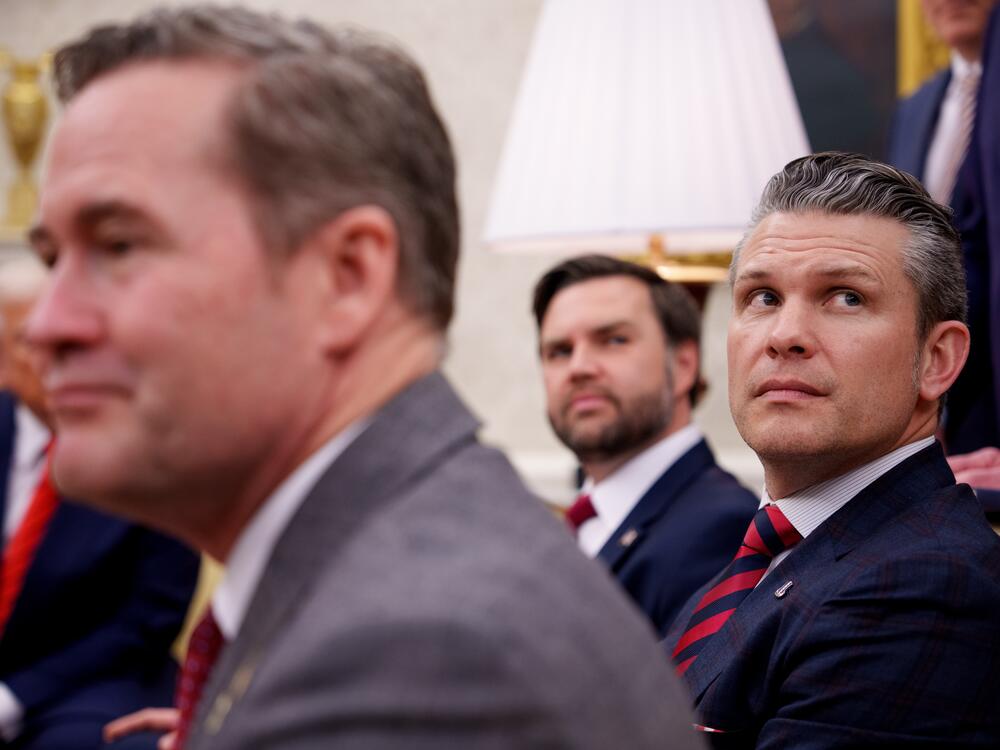 President Donald Trump, National Security Adviser Michael Waltz, Vice President JD Vance and Defense Secretary Pete Hegseth listen to a question from a reporter during a meeting in the Oval Office of the White House on March 13.