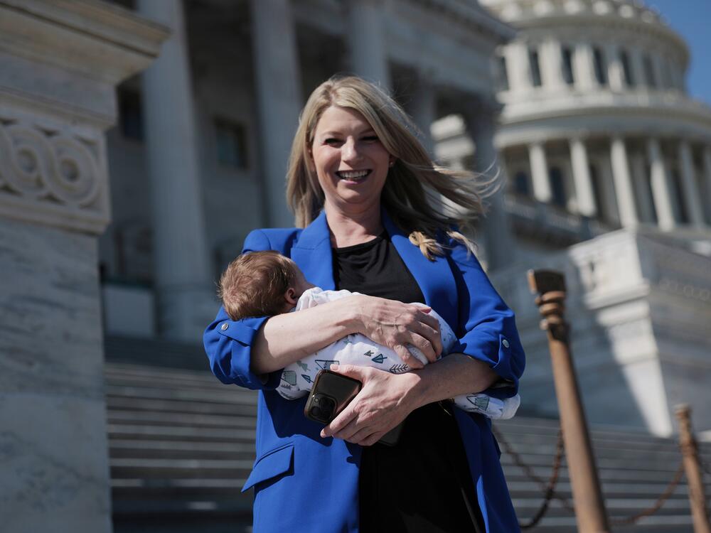 Rep. Brittany Pettersen, D-Colo., holds her one-month old baby as she departs during a series of votes at the Capitol on March 11.  Pettersen is currently working to pass legislation to allow proxy voting for up to 12 weeks for members who have recently given birth or whose spouse has.