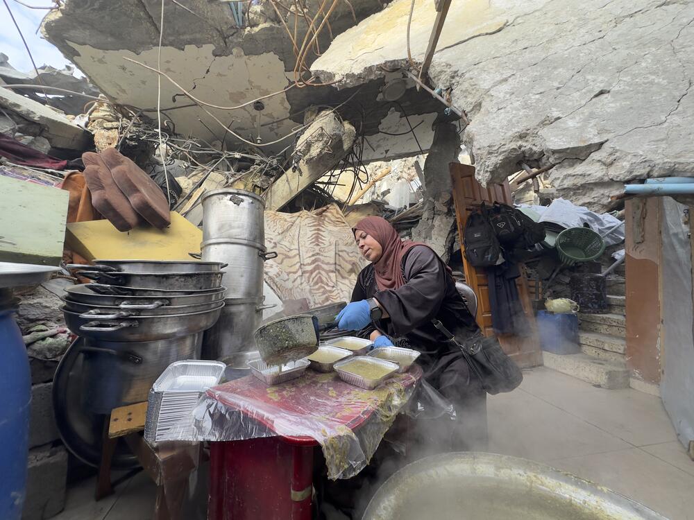 A meal is prepared amongst the ruins of  Gaza City, Gaza on March 9, 2025.