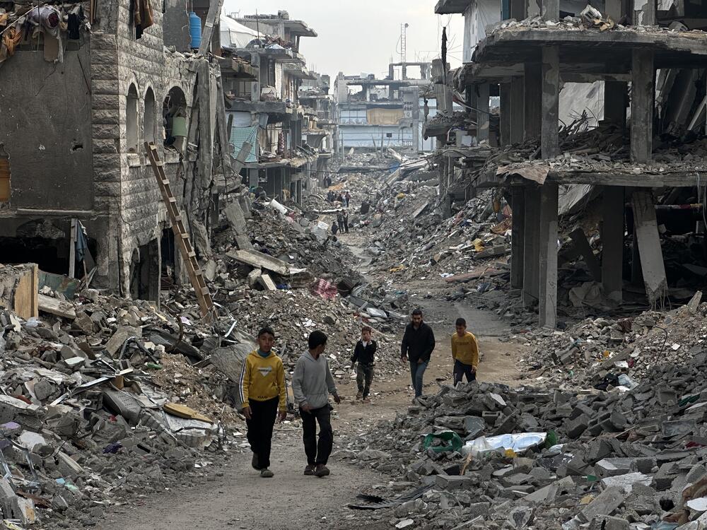 Palestinians walk through the rubble of Gaza City, Gaza on March 9, 2025.