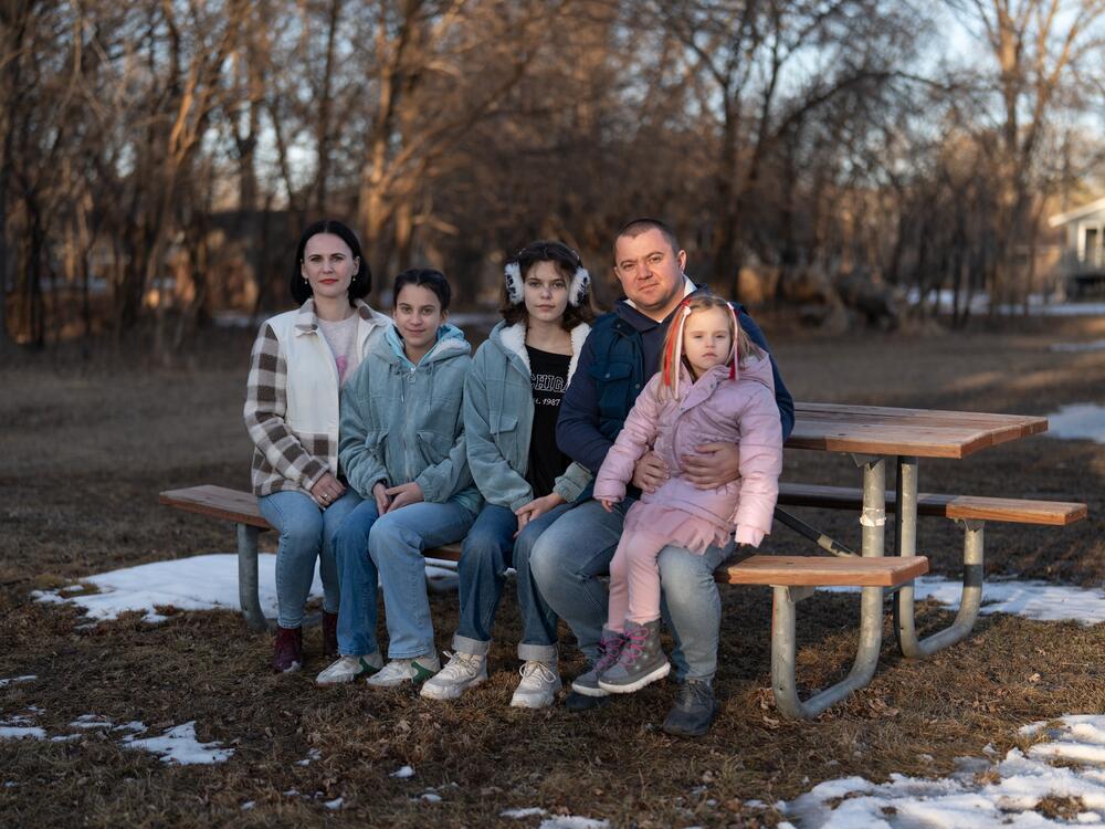 Members of the Holiuk family pose for a portrait near the home of their sponsors, Mark and Sharon Norlander, in Brooklyn Park, MN, March 8, 2025.