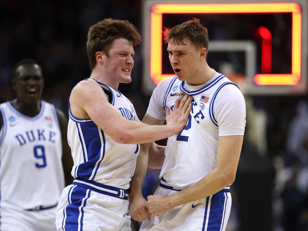 Cooper Flagg, right, and Kon Knueppel of the Duke Blue Devils react after Flagg scored a three-point basket to end the first half against the Arizona Wildcats in the East Regional Sweet 16 round of the NCAA Men's Basketball Tournament at Prudential Center on March 27, 2025 in Newark, New Jersey.