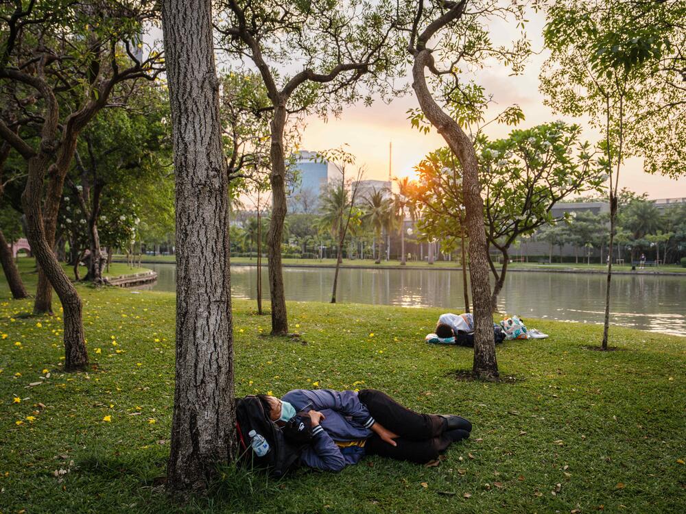 People sleep in the open at Chatuchak park in Bangkok on March 29, 2025, a day after an earthquake struck Myanmar and Thailand.