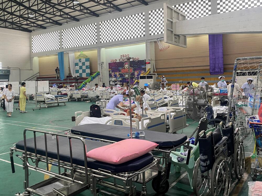 Patients are attended to in a makeshift medical treatment area in the recreational hall of a hospital in Bangkok on March 29, 2025.
