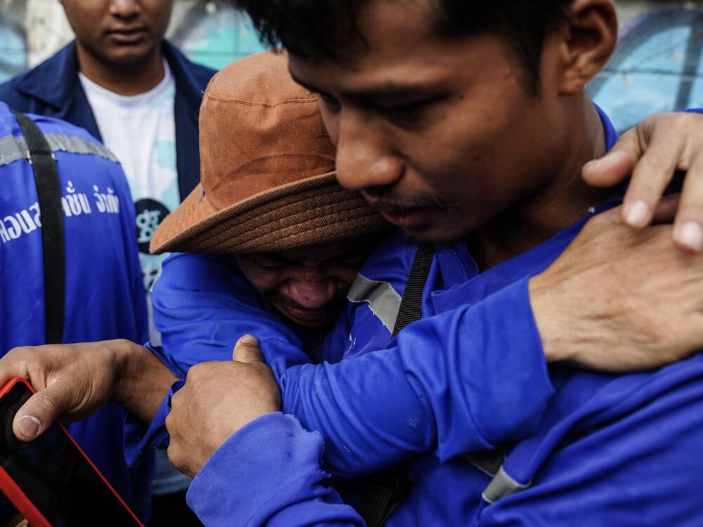 Relatives wait for missing family members during a search operation for survivors at the site of a collapsed building following an earthquake in Bangkok, Thailand, on March 29, 2025.