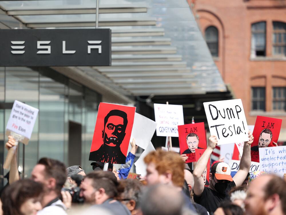 Demonstrators rally against Tesla CEO Elon Musk during a 