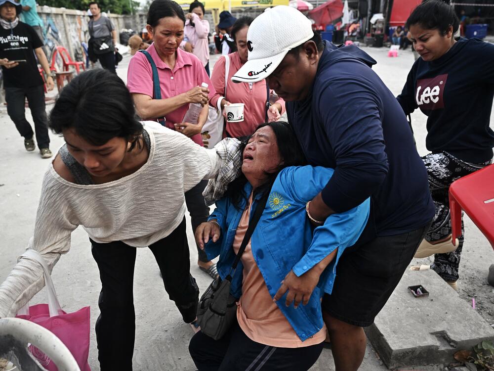 A woman reacts while waiting for news of missing loved ones at the site of an under-construction building collapse in Bangkok on March 30, 2025, two days after an earthquake struck central Myanmar and Thailand.