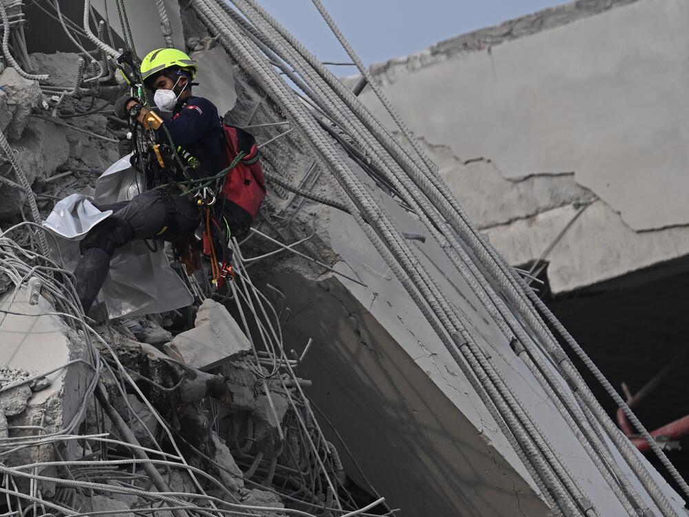 A rescue worker descends  at the site of an under-construction building collapse in Bangkok on March 30, 2025, two days after an earthquake struck central Myanmar and Thailand.