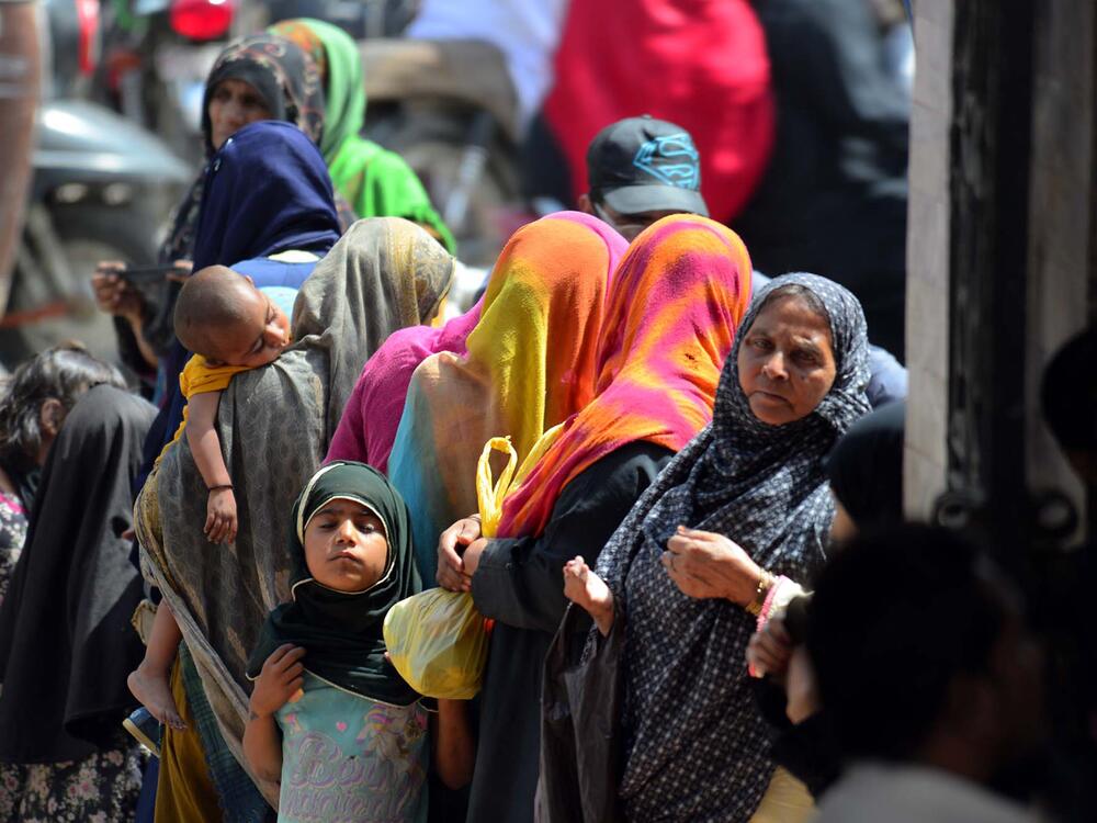 People beg for charity at Karachi's New Memon Mosque as large numbers arrive in Pakistan's biggest city from all over Sindh province to bring in extra money during the month of Ramadan, March 28.