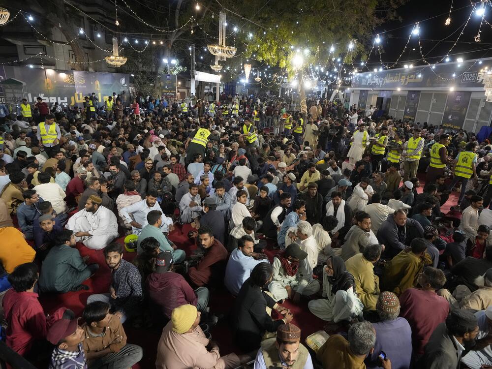 Volunteers distribute food among families for the pre-dawn sehri meal before starting their fast during the Muslim holy month of Ramadan, at a free meal distribution center run by a charity group in Karachi, March 2.
